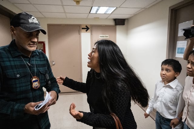 NEW YORK, NEW YORK - SEPTEMBER 25: The wife of the detained man from Ecuador pleads with a federal agent for her husband on September 25, 2025 in New York City. Despite getting continuances on their asylum claims, Federal agents will still detain immigrants who appear for their court dates at the Jacob K. Javits building at 26 Federal Plaza. (Photo by Stephanie Keith/Getty Images)