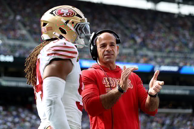 Defensive coordinator Robert Saleh of the San Francisco 49ers talks with Fred Warner during the game against the Seahawks at Lumen Field on Sept. 7, 2025, in Seattle.