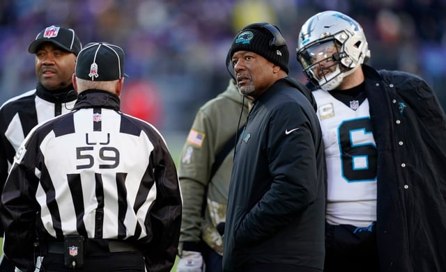 Carolina Panthers head coach Steve Wilks, center and quarterback Baker Mayfield, right, watch the Jumbotron for a review in the second half of an NFL football game Sunday, Nov. 20, 2022, in Baltimore. (AP Photo/Patrick Semansky)