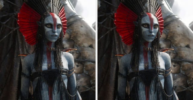 Fantasy character with elaborate headdress, face paint, and intricate costume, standing dramatically with a backdrop of large wings