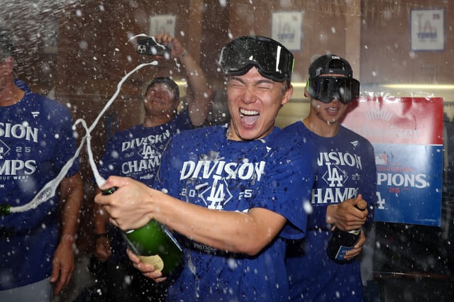 PHOENIX, ARIZONA - SEPTEMBER 25: Yoshinobu Yamamoto #18 of the Los Angeles Dodgers celebrates in the locker room after an 8-0 win over the Arizona Diamondbacks to clinch the National League West title at Chase Field on September 25, 2025 in Phoenix, Arizona. (Photo by Chris Coduto/Getty Images)