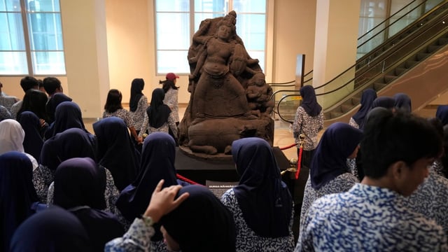 A group of students walk past the statue of Hindu goddess Durga Mahisasuramardini at the National Museum in Jakarta, Indonesia, in January. The Netherlands has announced it is returning a further 28,000 fossils to Indonesia, including the bones of 'Java Man.' 