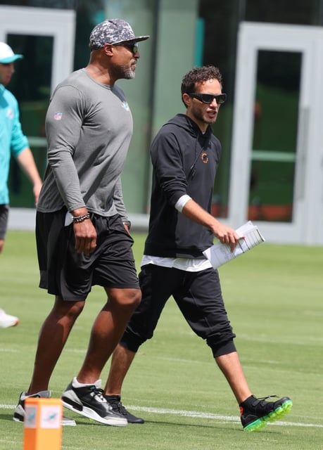 Miami Dolphins defensive coordinator Anthony Weaver chat with head coach Mike McDaniel during practice at the Baptist Health Training Complex in Miami Gardens on Thursday, Sept. 25, 2025. (Carline Jean/South Florida Sun Sentinel)