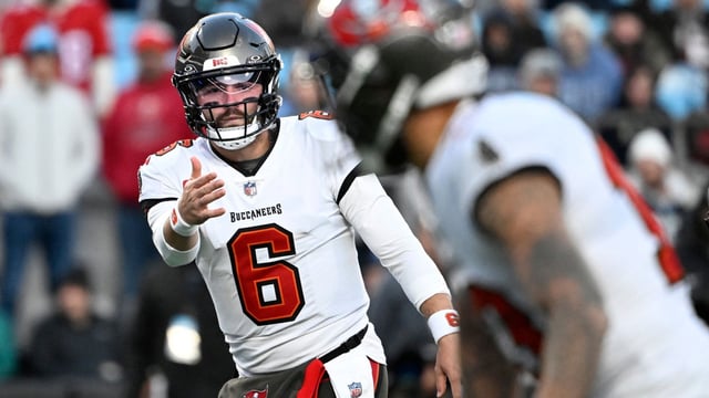 Dec 1, 2024; Charlotte, North Carolina, USA;  Tampa Bay Buccaneers quarterback Baker Mayfield (6) signals to wide receiver Mike Evans (13) in the first quarter at Bank of America Stadium.
