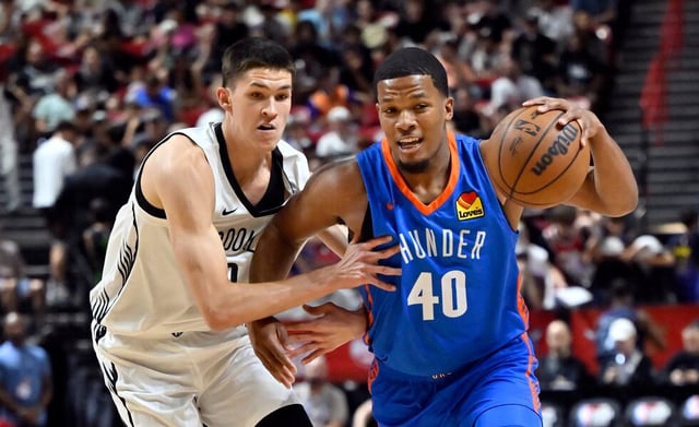 Oklahoma City Thunder guard Chris Youngblood (40) handles the ball against Brooklyn Nets guard Egor Dëmin (8) during the first half of an NBA summer league basketball game Thursday, July 10, 2025, in Las Vegas.