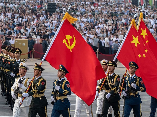 BEIJING, CHINA - SEPTEMBER 3: Chinese soldiers march with the national flag, the flag of the Communist Party of China, and the People's Liberation Army during a military parade marking the 80th anniversary of victory over Japan and the end of World War II, in Tiananmen Square on September 3, 2025, in Beijing, China. China's Victory Day military parade serves as a powerful display of national pride and military power. This year's parade carries heightened geopolitical weight with the attendance of 26 world leaders, including Russian President Vladimir Putin, North Korean leader Kim Jong Un, and Iranian President Masoud Pezeshkian, underlining China's diplomatic alliances as it presents itself as an alternative global leader. (Photo by Kevin Frayer/Getty Images)