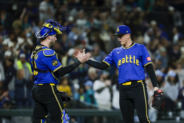 Sep 25, 2025; Seattle, Washington, USA; Seattle Mariners catcher Mitch Garver (18) shakes hands with pitcher Casey Legumina (64) following a victory against the Colorado Rockies inning at T-Mobile Park. Mandatory Credit: Joe Nicholson-Imagn Images/File Photo