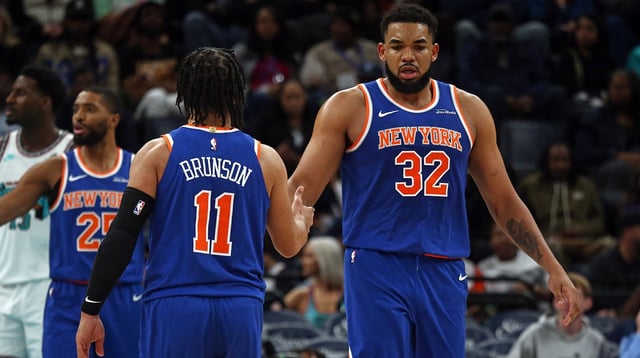 Feb 28, 2025; Memphis, Tennessee, USA; New York Knicks center Karl-Anthony Towns (32) reacts with guard Jalen Brunson (11) during the third quarter against the Memphis Grizzlies at FedExForum. Mandatory Credit: Petre Thomas-Imagn Images