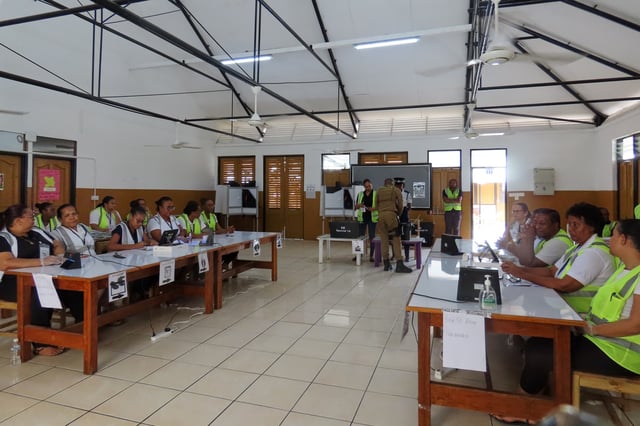 Electoral commission staff monitor voting, inside a classroom as people cast their votes at the polling station at English River School in Victoria, Seychelles, Thursday, Sept. 25, 2025. (AP Photo/Emilie Chetty)