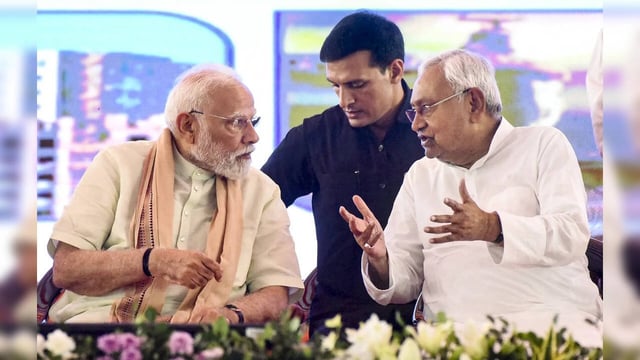 Purnea: Prime Minister Narendra Modi with Bihar Chief Minister Nitish Kumar duri...