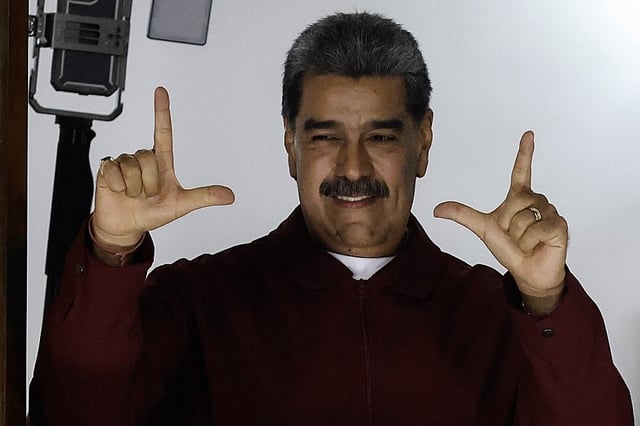 Venezuelan president Nicolas Maduro gestures while speaking after results were released following municipal elections in Caracas, Venezuela, in the early morning of July 28, 2025. Venezuela's ruling party won the majority of mayoral seats on Sunday in elections boycotted by the main opposition, coinciding with the anniversary of President Nicolas Maduro's re-election last year. The ruling United Socialist Party of Venezuela (PSUV) won 285 of 335 mayoralties, according to Maduro's own projections, which he celebrated with supporters early Monday in Caracas's Bolivar Square. (Photo by Pedro MATTEY / AFP)