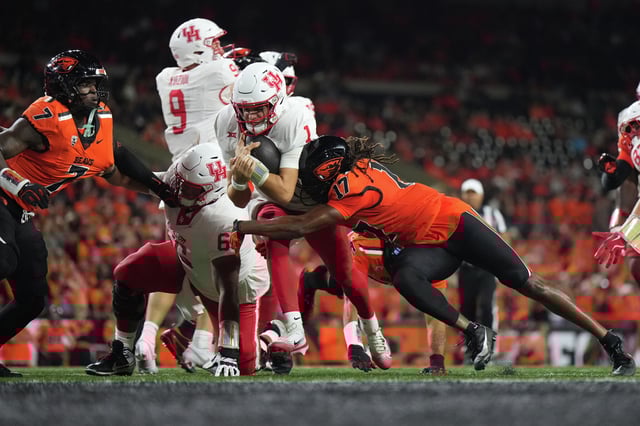 Conner Weigman #1 of the Houston Cougars is tackled by Skyler Thomas #17 of the Oregon State Beavers during the first half at Reser Stadium on September 26, 2025 in Corvallis, Oregon. (Photo by Soobum Im/Getty Images)