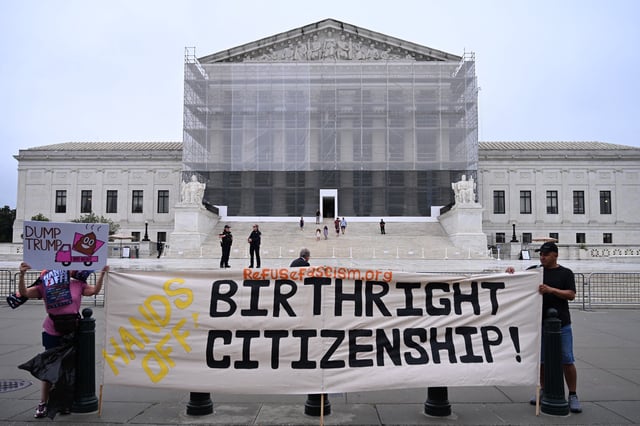 Demonstrators holds up an anti-Trump sign outside the US Supreme Court in Washington, DC, on June 27, 2025.