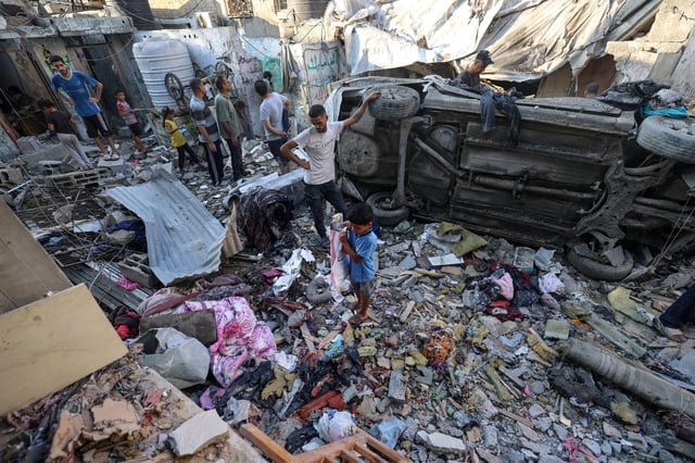 Palestinians check the damage outside a house hit by Israeli bombing in the Nuseirat refugee camp in the central Gaza Strip on Saturday. 