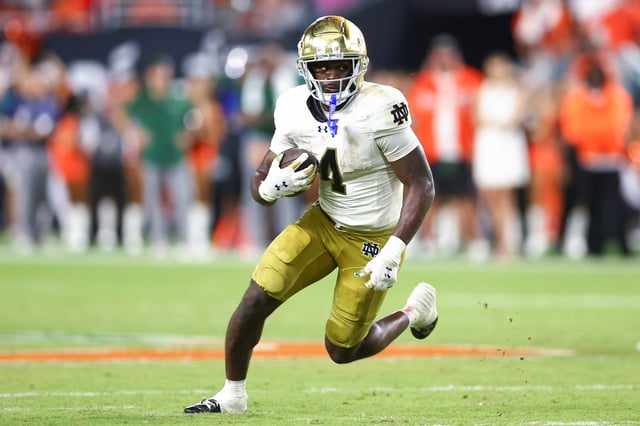 Jeremiyah Love #4 of the Notre Dame Fighting Irish carries the ball against the Miami Hurricanes during the fourth quarter of the game at Hard Rock Stadium on August 31, 2025 in Miami Gardens, Florida.