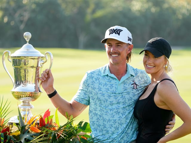 FILE - Jake Knapp, of the United States, and his girlfriend Makena White pose with his trophy during the award ceremony after winning the Mexico Open golf tournament in Puerto Vallarta, Mexico, Sunday, Feb. 25, 2024. (AP Photo/Fernando Llano, File)