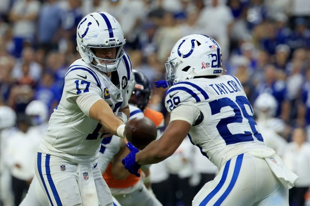 Indianapolis Colts quarterback Daniel Jones, left, hands off to running back Jonathan Taylor during the fourth quarter against the Denver Broncos on Sept. 14, 2025, in Indianapolis. (Photo by Justin Casterline/Getty Images)