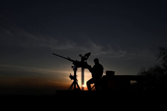 A service member stands next to a M2 Browning machine gun during a combat shift on the front line, amid Russia's attack on Ukraine, in Kharkiv region, Ukraine September 15, 2025. REUTERS/Stringer/File Photo