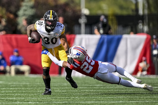 Sep 21, 2025; Foxborough, Massachusetts, USA; New England Patriots cornerback Marcus Jones (25) attempts to tackle Pittsburgh Steelers running back Jaylen Warren (30) during the fourth quarter at Gillette Stadium. Mandatory Credit: Brian Fluharty-Imagn Images/File Photo