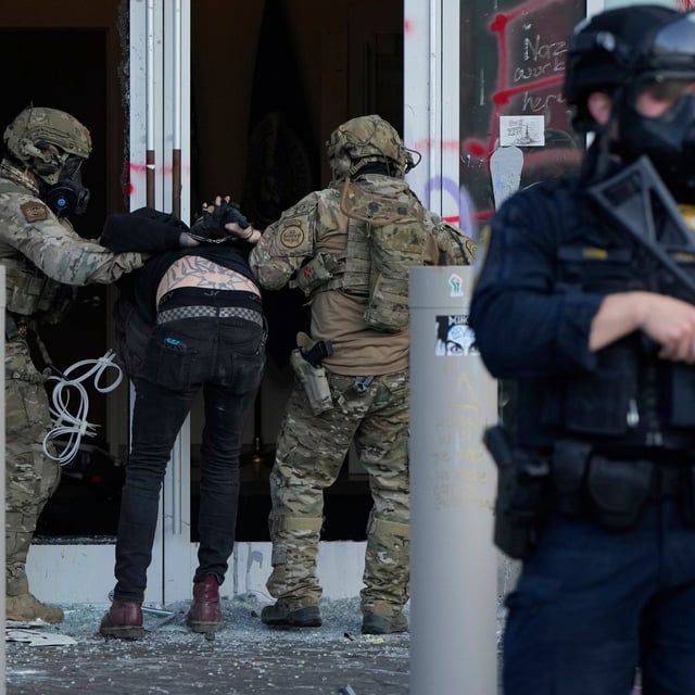 FILE - U.S. Customs and Border Protection agents detain a man outside the U.S. Immigration and Customs building during a protest in Portland, Ore., June 14, 2025. (AP Photo/Jenny Kane, File)