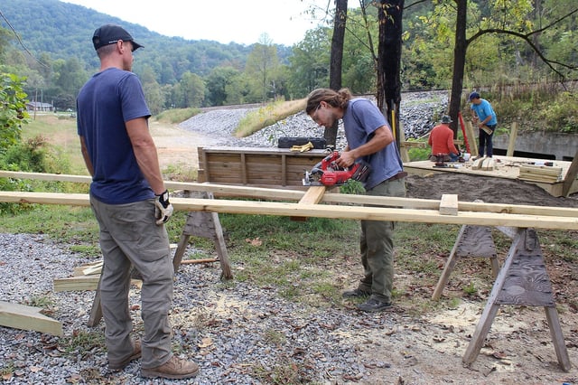 Trail specialist Mac Pfeifer (right) and volunteer Dan Currence work on a new trailhead for a bike trail outside Old Fort, North Carolina, Sept. 24, 2025. 