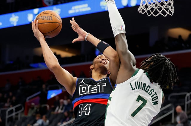 Detroit Pistons guard Wendell Moore Jr. (14) takes a shot against Milwaukee Bucks forward Chris Livingston (7) during the second half of an Emirates NBA Cup basketball game Tuesday, Dec. 3, 2024, in Detroit. (AP Photo/Duane Burleson)
