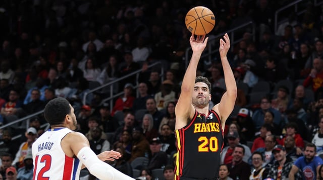 Feb 23, 2025; Atlanta, Georgia, USA; Atlanta Hawks forward Georges Niang (20) attempts three-point shot against Detroit Pistons forward Tobias Harris (12) during the third quarter at State Farm Arena. Mandatory Credit: Jordan Godfree-Imagn Images