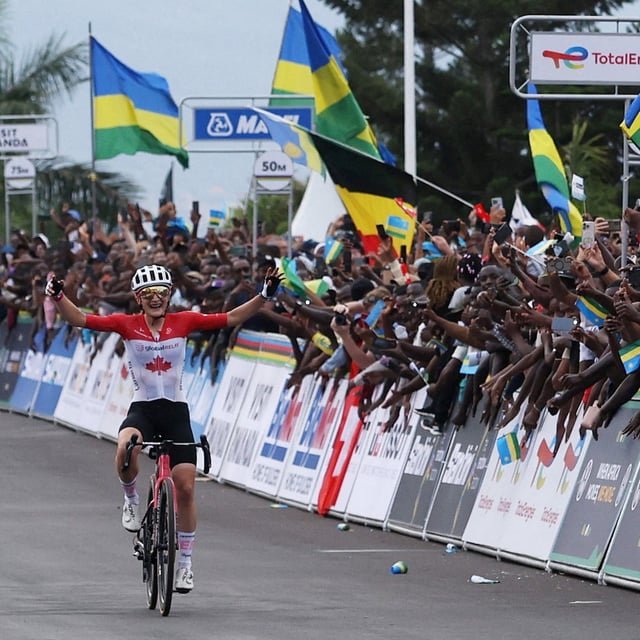 Canada's Magdeleine Vallieres celebrates as she crosses the finish line to win the women's elite road race.