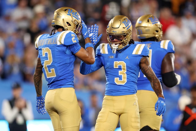 Titus Mokiao-Atimalala #2 and Kwazi Gilmer #3 of the UCLA Bruins celebrate a touchdown against the New Mexico Lobos during the second quarter at Rose Bowl Stadium on September 12, 2025 in Pasadena, California.