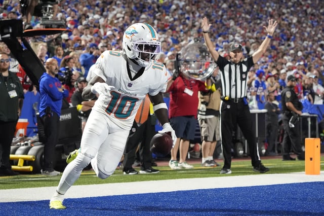 Sep 18, 2025; Orchard Park, New York, USA;  Miami Dolphins wide receiver Tyreek Hill (10) scores a touchdown against the Buffalo Bills in the fourth quarter at Highmark Stadium. Mandatory Credit: Gregory Fisher-Imagn Images/File Photo