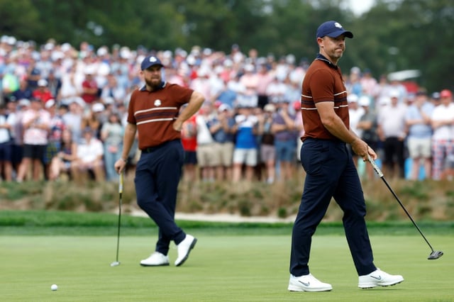 Rory McIlroy, right, reacts to heckling while Europe teammate Shane Lowry watches during a four-balls match in the 45th Ryder Cup at Bethpage Black