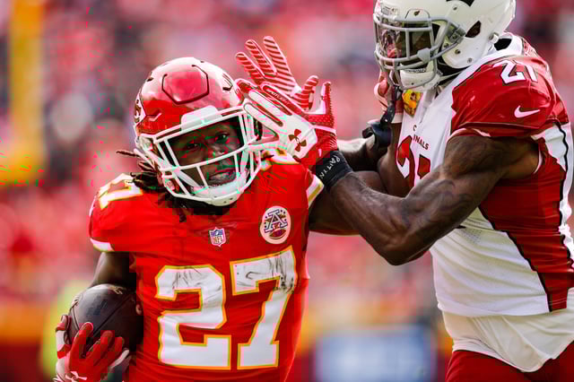 Kareem Hunt #27 of the Kansas City Chiefs tries to fight off a tackle from Patrick Peterson #21 of the Arizona Cardinals during the first half of the game at Arrowhead Stadium on November 11, 2018 in Kansas City, Missouri.