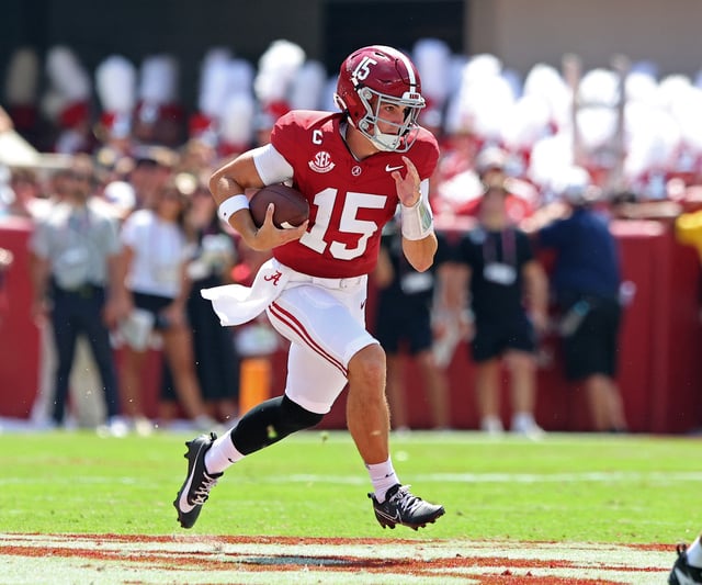 Ty Simpson #15 of the Alabama Crimson Tide runs the ball for a gain during the first half of the game against the Wisconsin Badgers at Bryant-Denny Stadium on September 13, 2025 in Tuscaloosa, Alabama.