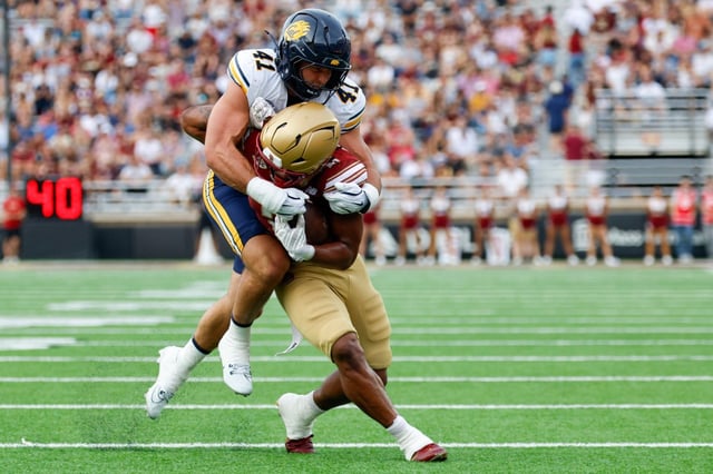 Boston College running back Turbo Richard (2) is tackled by California linebacker Luke Ferrelli (41) during the first half of an NCAA football game on Saturday, Sept. 27, 2025, in Chestnut Hill, Mass. (AP Photo/Greg M. Cooper)