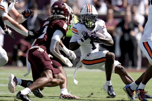 Auburn wide receiver Eric Singleton Jr. (1) looks for a whole to run against the Texas A&M defense during the first half of an NCAA college football game Saturday, Sept. 27, 2025, in College Station, Texas. (AP Photo/Sam Craft)