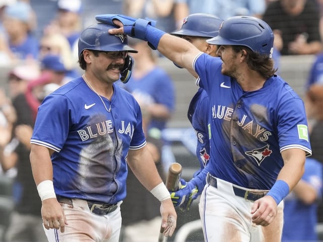 Toronto Blue Jays' Addison Barger (47) and Davis Schneider (36) celebrate after Jays' Ernie Clement hit a two run RBI double off Tampa Bay Rays pitcher Joe Boyle (36) during second inning MLB baseball action in Toronto, Saturday, Sept. 27, 2025.