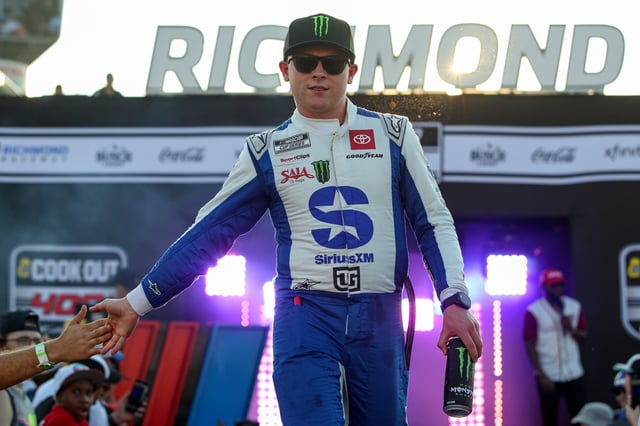 Ty Gibbs, driver of the #54 SiriusXM Toyota, greets fans as he walks onstage during driver intros prior to the NASCAR Cup Series Cook Out 400 at Richmond Raceway on August 16, 2025 in Richmond, Virginia.