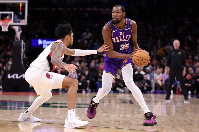 PHOENIX, ARIZONA - DECEMBER 15: Kevin Durant #35 of the Phoenix Suns controls the ball against Anfernee Simons #1 of the Portland Trail Blazers during the second half at Footprint Center on December 15, 2024 in Phoenix, Arizona. NOTE TO USER: User expressly acknowledges and agrees that, by downloading and or using this photograph, User is consenting to the terms and conditions of the Getty Images License Agreement.  (Photo by Chris Coduto/Getty Images)
