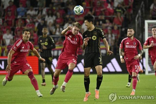 Son Heung-min of Los Angeles Football Club (R) and Conrad Wallem of St. Louis City SC battle for the ball during their clubs' Major League Soccer regular-season match at Energizer Park in St. Louis on Sept. 27, 2025, in this Imagn Images photo via Reuters. (Yonhap)