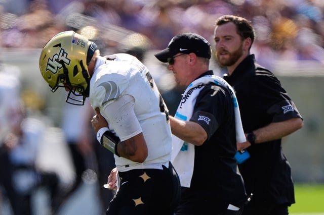 Central Florida quarterback Tayven Jackson is helped off the field after an injury during the first half of an NCAA college football game against Kansas State, Saturday, Sept. 27, 2025, in Manhattan, Kan. (AP Photo/Charlie Riedel)