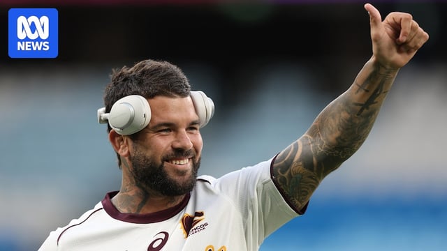 Adam Reynolds of the Broncos smiling, giving a thumbs up, with headphones on, in a warm up before an NRL match