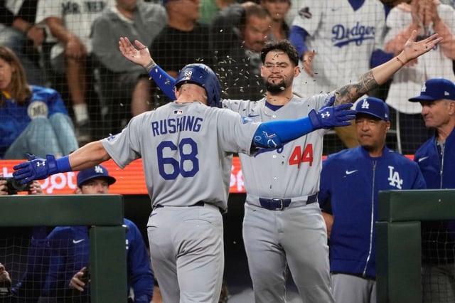Dodgers’ Dalton Rushing (68) celebrates with Andy Pages (44) after hitting a two-run go-ahead home run that scored Miguel Rojas during the fifth inning of a baseball game against the Seattle Mariners, Saturday, Sept. 27, 2025, in Seattle. (AP Photo/Ryan Sun)