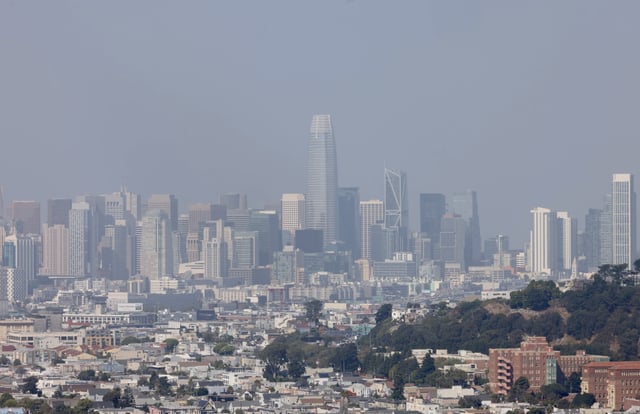A smoky haze blankets San Francisco in 2023. People are reporting smoke smells in the city as Oregon wildfires burn.