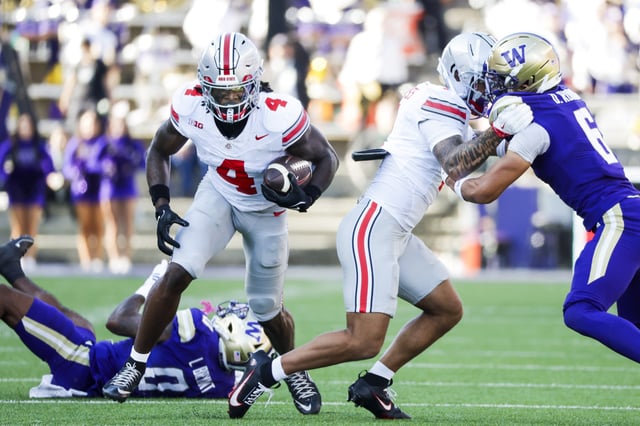 Sep 27, 2025; Seattle, Washington, USA; Ohio State Buckeyes wide receiver Jeremiah Smith (4) runs for yards after the catch against the Washington Huskies during the third quarter at Husky Stadium. Mandatory Credit: Joe Nicholson-Imagn Images
