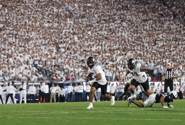 Sep 27, 2025; University Park, Pennsylvania, USA; Oregon Ducks quarterback Dante Moore (5) runs for a gain during the fourth quarter against the Penn State Nittany Lions at Beaver Stadium. Mandatory Credit: Matthew O'Haren-Imagn Images