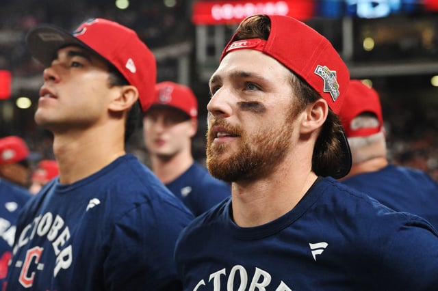 Sep 27, 2025; Cleveland, Ohio, USA; Cleveland Guardians starting pitcher Joey Cantillo (54) and second baseman Daniel Schneemann (10) watch a video as they celebrate after the Guardians beat the Texas Rangers to secure a playoff berth at Progressive Field. Mandatory Credit: Ken Blaze-Imagn Images