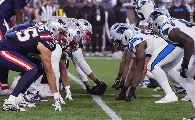 New England Patriots quarterback Joe Milton III, left, lines up against the Carolina Panthers during the second half of a preseason NFL football game, Thursday, Aug. 8, 2024, in Foxborough, Mass. (AP Photo/Michael Dwyer)