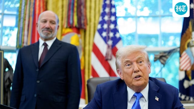 Howard Lutnick, US commerce secretary, stands behind President Donald Trump at the Oval Office in the White House in Washington.