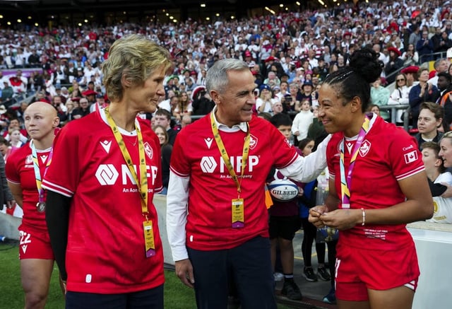 Prime Minister Mark Carney and wife Diana Fox Carney talk to Canada's Asia Hogan-Rochester after winning silver in the Women's Rugby World Cup at Allianz Stadium, the London suburb of Twickenham, U.K., Saturday, Sept. 27, 2025. THE CANADIAN PRESS/Sean Kilpatrick