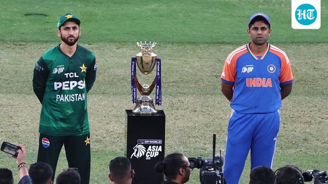 India's captain Suryakumar Yadav (L) and his Pakistani counterpart Salman Agha stand on the field for the toss before the start of the Asia Cup 2025 final